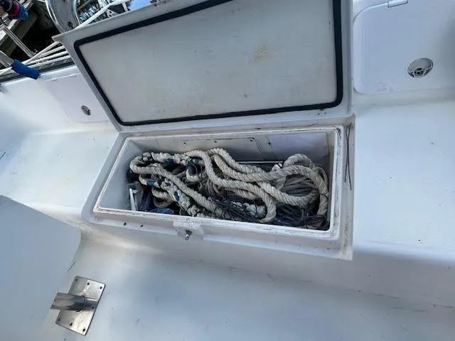  Yacht Photos Pics Open storage compartment on 1995 Lagoon TPI 37 sailboat with ropes inside.
