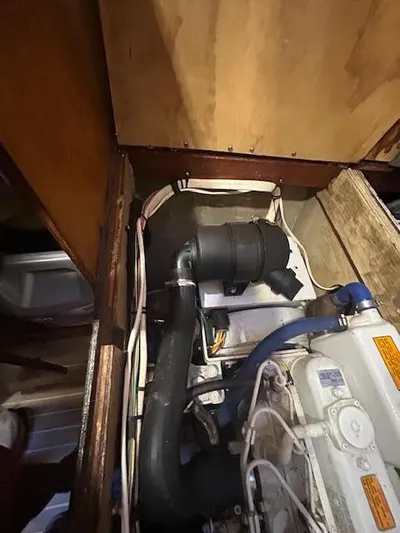 Yacht Photos Pics Engine compartment of a 1995 Lagoon TPI 37 sailboat, showing hoses and components.