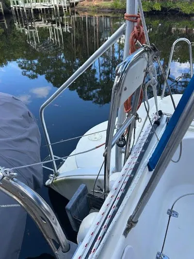  Yacht Photos Pics 1995 Lagoon TPI 37 sailboat docked by calm water, featuring deck and railing details.