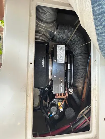  Yacht Photos Pics Engine compartment of a 1995 Lagoon TPI 37 boat, showcasing mechanical components.