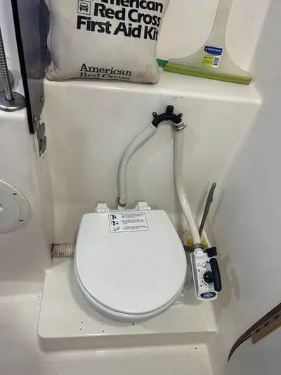  Yacht Photos Pics Boat toilet with manual pump in 1995 Lagoon TPI 37, featuring first aid kit nearby.