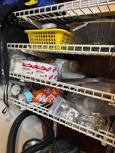  Yacht Photos Pics Storage shelves with assorted boat supplies and tools for a 1995 Lagoon TPI 37.