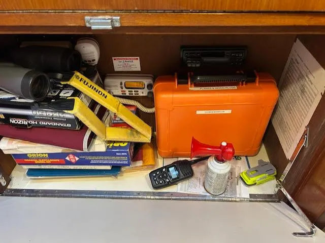  Yacht Photos Pics Storage compartment on a 1995 Lagoon TPI 37 with safety equipment and navigation tools.