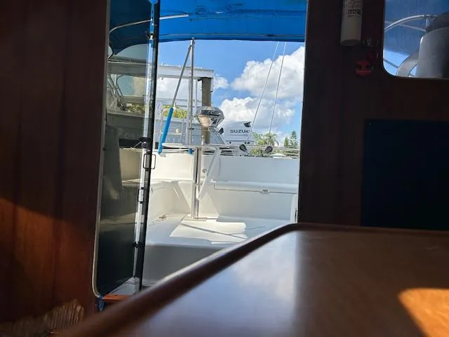  Yacht Photos Pics Interior view of 1995 Lagoon TPI 37 sailboat with open cockpit and blue canopy.