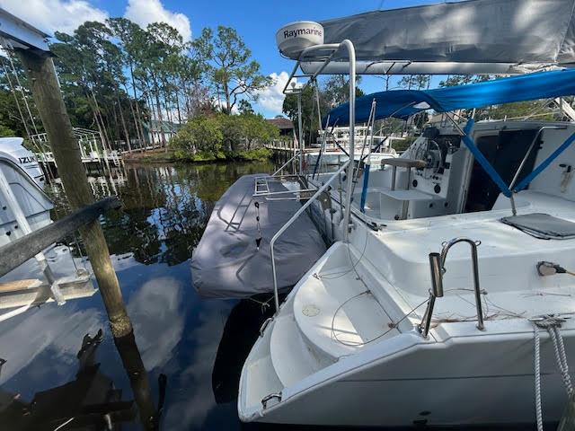 1995 Lagoon TPI 37 catamaran docked in a serene marina setting.