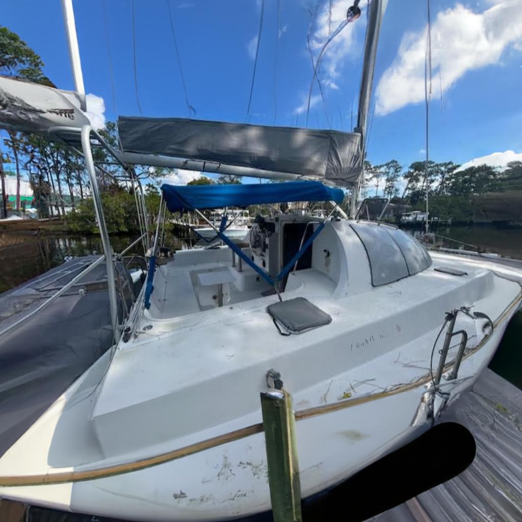 1995 Lagoon TPI 37 sailboat with blue canopy,
