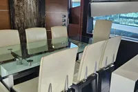 Luxurious dining area on 2008 Astondoa A76 GLX yacht with glass table and white chairs.