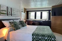 Luxurious bedroom interior of 2008 Astondoa A76 GLX yacht, featuring elegant decor and large window.