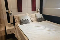 Luxurious bedroom interior of 2008 Astondoa A76 GLX yacht, featuring elegant bedding and modern decor.