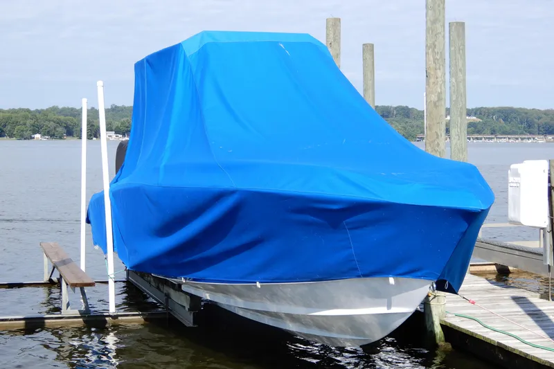  Yacht Photos Pics 2021 Concept 32' Open Deck boat covered with blue tarp at dockside.