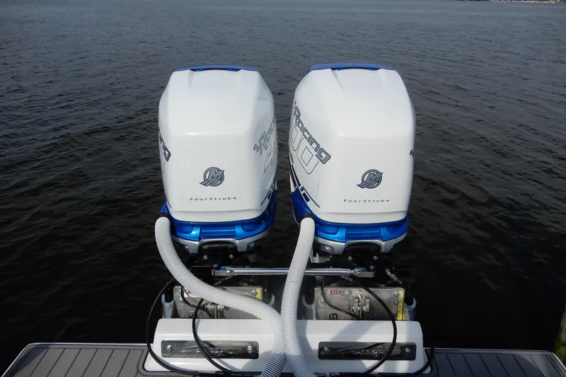  Yacht Photos Pics Twin outboard engines on a 2021 Concept 32' Open Deck boat, floating on calm water.
