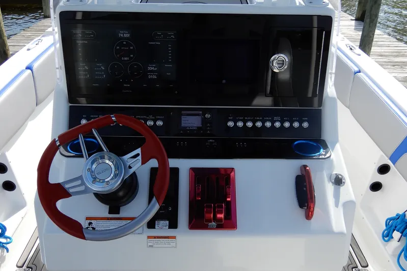  Yacht Photos Pics 2021 Concept 32' Open Deck boat dashboard with red steering wheel and control panel.