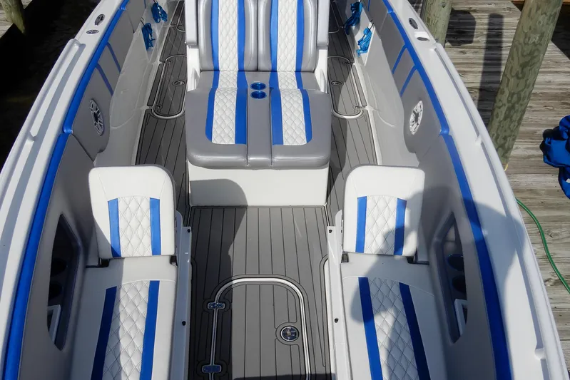  Yacht Photos Pics 2021 Concept 32' Open Deck boat with blue and white seating, docked on wooden pier.