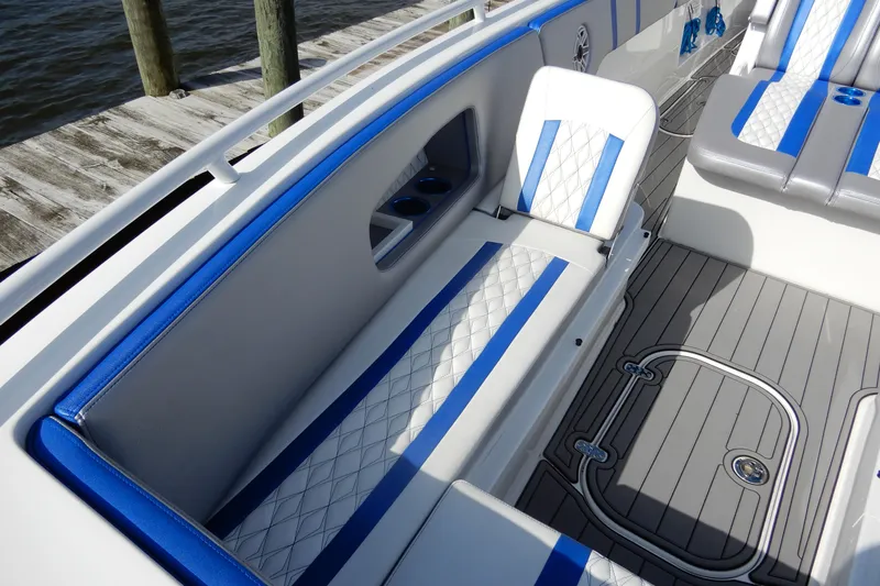  Yacht Photos Pics 2021 Concept 32' Open Deck boat interior with blue and white seating, dockside view.