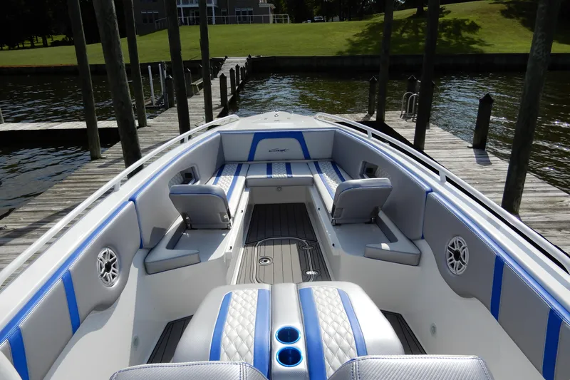  Yacht Photos Pics 2021 Concept 32' Open Deck boat with blue and gray seating, docked by a wooden pier.