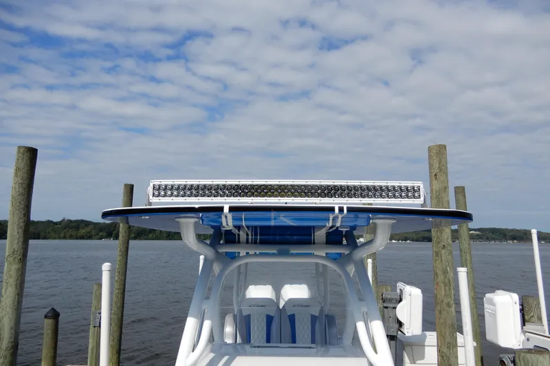  Yacht Photos Pics 2021 Concept 32' Open Deck boat docked by the water under a cloudy sky.