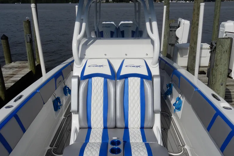  Yacht Photos Pics 2021 Concept 32' Open Deck boat with blue and white seating at a dock.