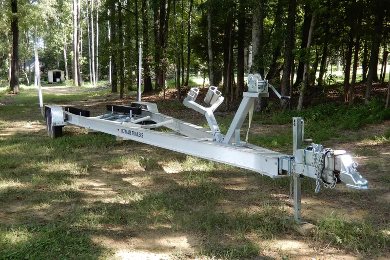  Yacht Photos Pics 2021 Concept 32' Open Deck trailer in a wooded area, showcasing sturdy design and construction.