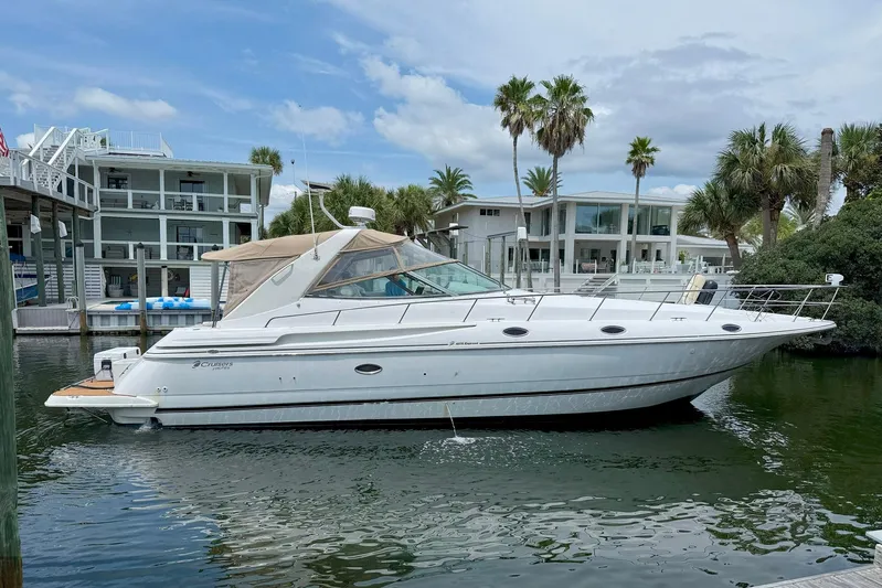 Creme Brulee Yacht Photos Pics 2001 Cruisers Yachts 4270 Express docked near modern waterfront homes.