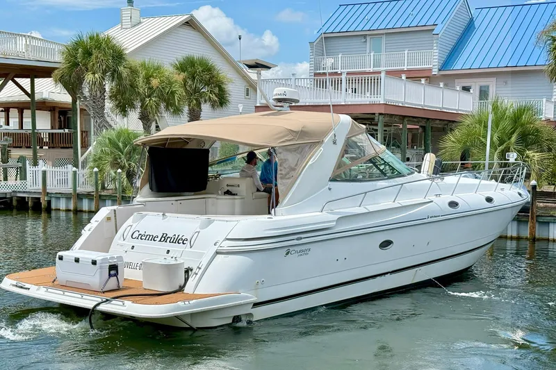 Creme Brulee Yacht Photos Pics 2001 Cruisers Yachts 4270 Express docked near waterfront homes.