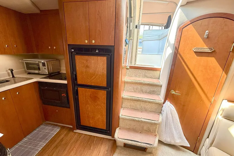 Creme Brulee Yacht Photos Pics Interior of 2001 Cruisers Yachts 4270 Express, featuring kitchen and stairs to deck.