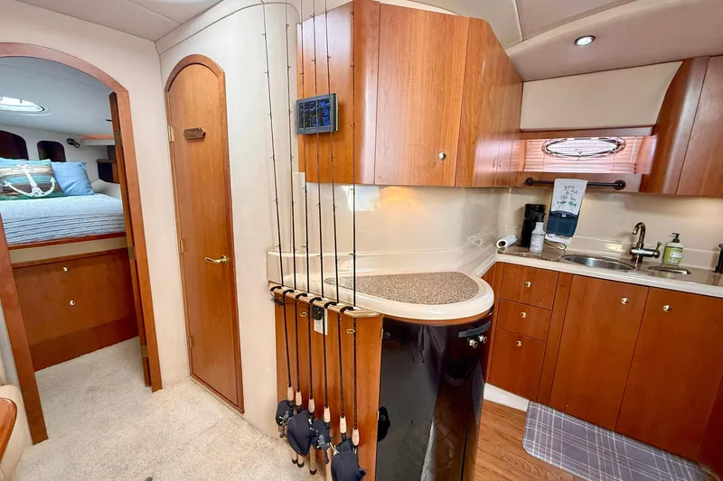 Creme Brulee Yacht Photos Pics Interior of 2001 Cruisers Yachts 4270 Express, featuring kitchen and cozy bedroom.