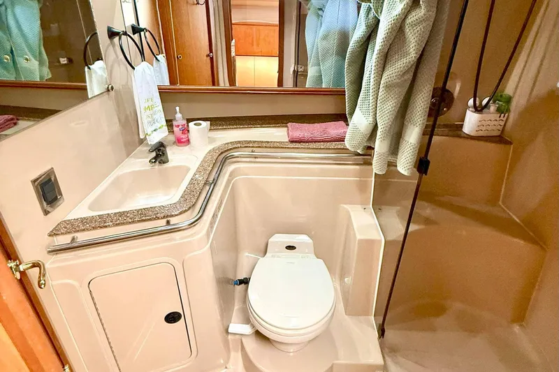 Creme Brulee Yacht Photos Pics Luxurious bathroom in 2001 Cruisers Yachts 4270 Express, featuring sink and toilet.