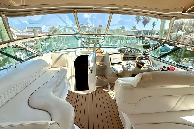 Creme Brulee Yacht Photos Pics 2001 Cruisers Yachts 4270 Express cockpit with luxurious seating and modern navigation equipment.