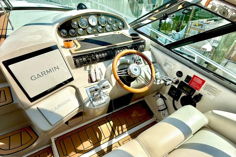Creme Brulee Yacht Photos Pics 2001 Cruisers Yachts 4270 Express helm with Garmin navigation and wood-accented steering wheel.