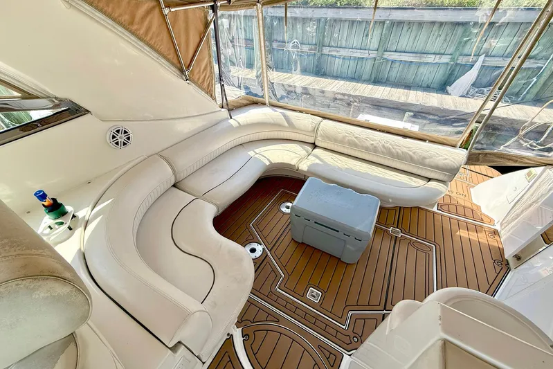 Creme Brulee Yacht Photos Pics 2001 Cruisers Yachts 4270 Express interior with white seating and wooden flooring.