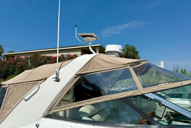 Creme Brulee Yacht Photos Pics 2001 Cruisers Yachts 4270 Express with beige canopy and radar equipment, docked under clear skies.