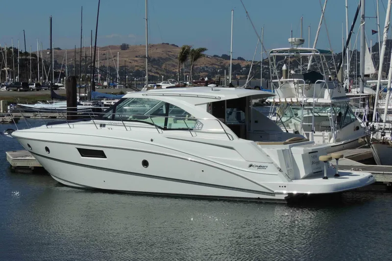 Osa Yacht Photos Pics 2012 Cruisers Yachts 41 Cantius docked in a marina, surrounded by sailboats.
