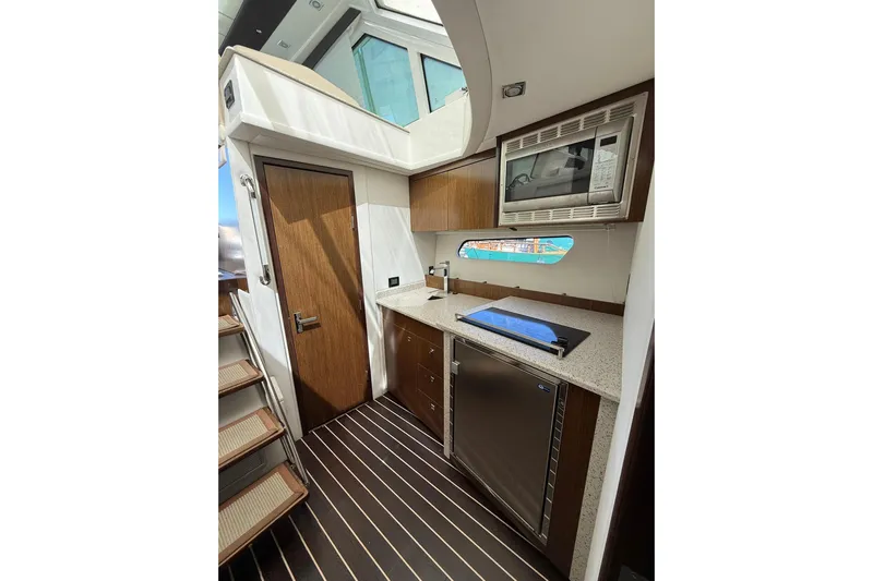 Osa Yacht Photos Pics Luxurious 2012 Cruisers Yachts 41 Cantius galley with modern appliances and sleek wood finishes.