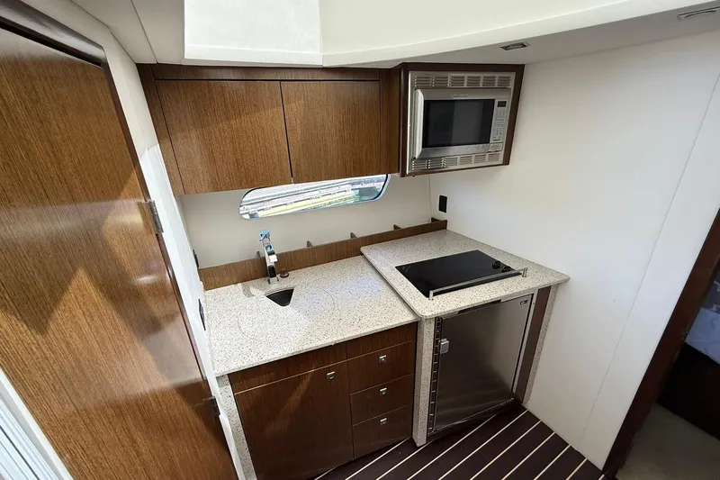 Osa Yacht Photos Pics 2012 Cruisers Yachts 41 Cantius galley with modern appliances and wood cabinetry.