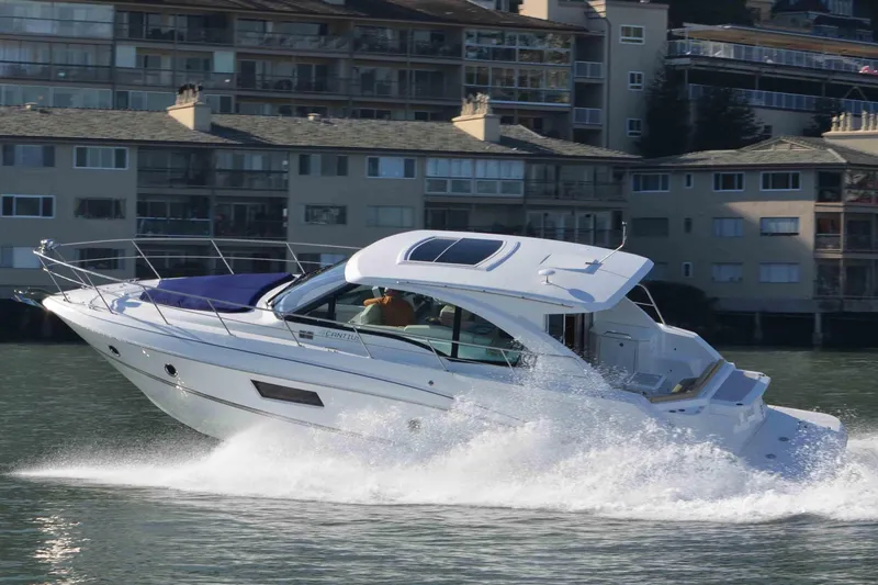 Osa Yacht Photos Pics 2012 Cruisers Yachts 41 Cantius speeding on water near residential buildings.