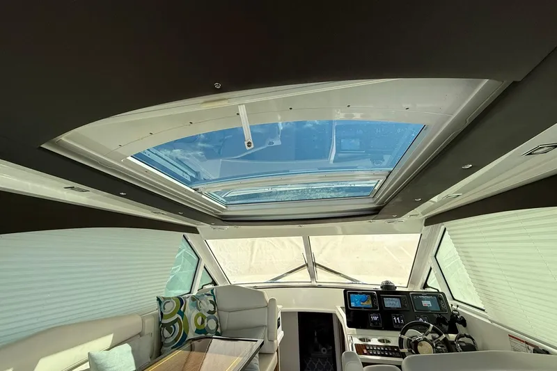 Osa Yacht Photos Pics Interior view of 2012 Cruisers Yachts 41 Cantius with skylight and modern helm.