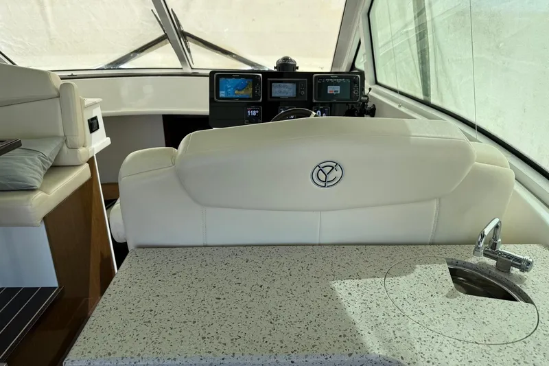 Osa Yacht Photos Pics Interior of 2012 Cruisers Yachts 41 Cantius with helm, seating, and sink.