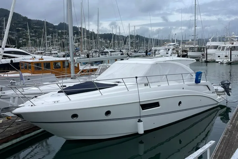 Osa Yacht Photos Pics 2012 Cruisers Yachts 41 Cantius docked in a marina with sailboats.