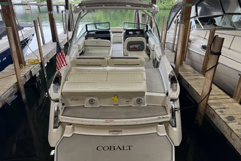  Yacht Photos Pics 2021 Cobalt R30 boat docked, featuring spacious seating and sleek design.