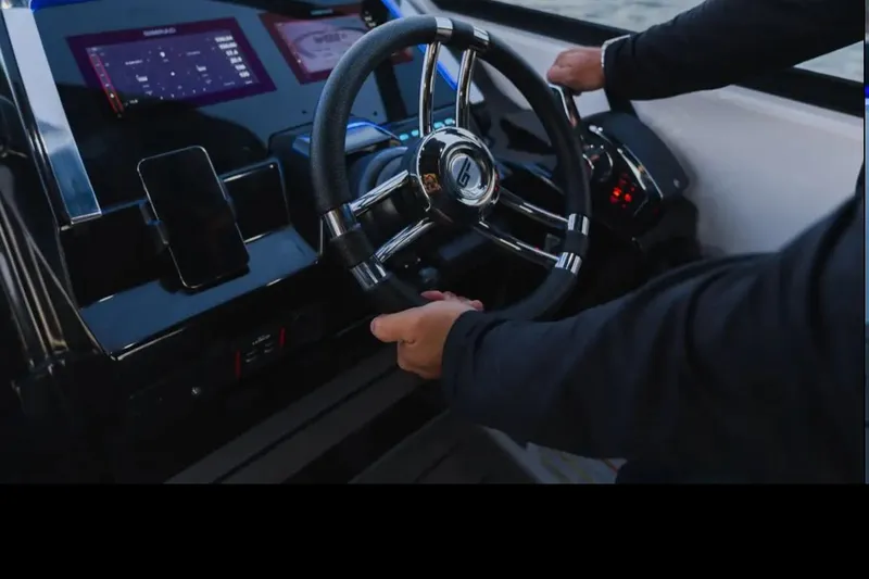  Yacht Photos Pics Steering wheel of 2026 Granfort 300 GTS boat with modern dashboard controls.