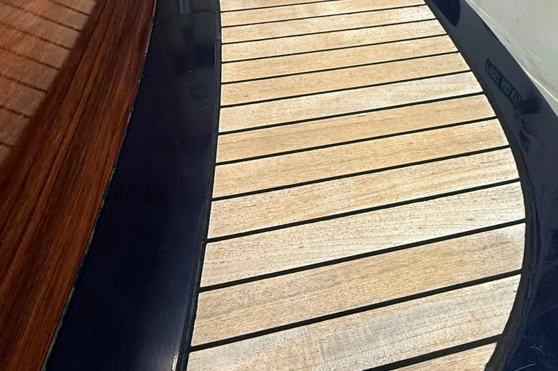 Wayfarer Yacht Photos Pics Teak deck detail of 2002 Hinckley Talaria 29C boat, showcasing elegant wood craftsmanship.