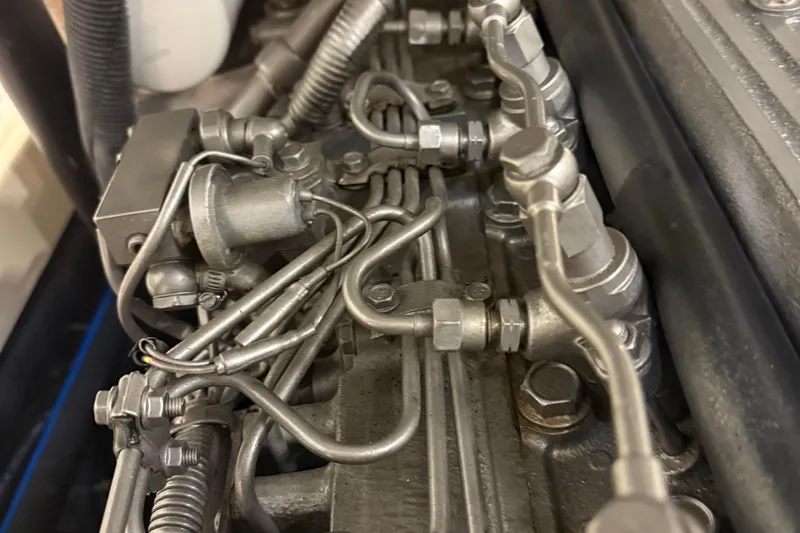 Wayfarer Yacht Photos Pics Close-up of a 2002 Hinckley Talaria 29C engine components, showcasing intricate metal piping.