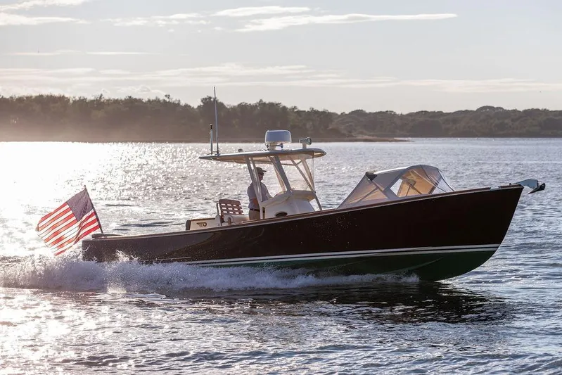 Wayfarer Yacht Photos Pics 2002 Hinckley Talaria 29C cruising on a sunlit lake with American flag.