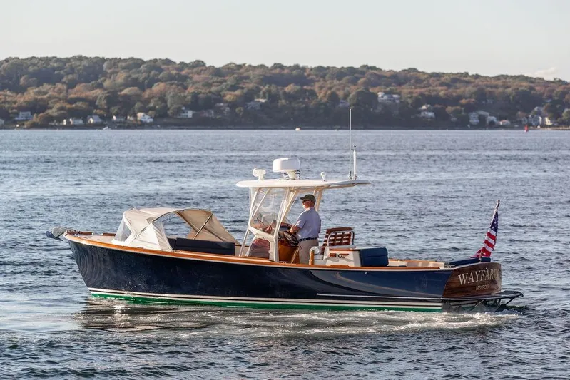 Wayfarer Yacht Photos Pics 2002 Hinckley Talaria 29C cruising on a scenic lake with wooded shoreline.