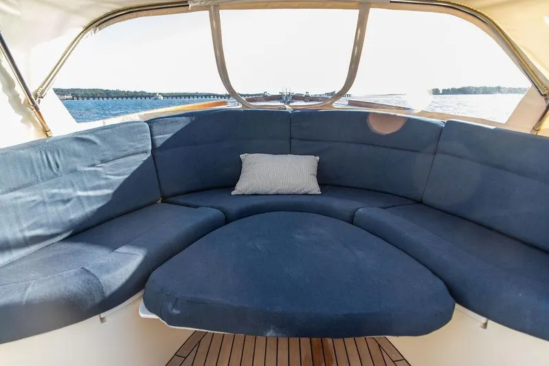 Wayfarer Yacht Photos Pics Luxurious seating area on a 2002 Hinckley Talaria 29C yacht with blue cushions.