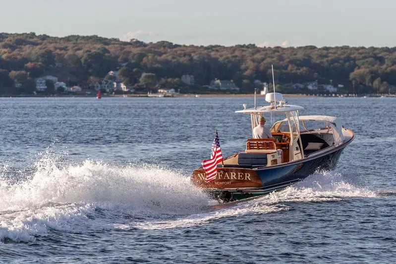 Wayfarer Yacht Photos Pics 2002 Hinckley Talaria 29C cruising on a scenic lake with American flag.