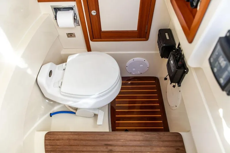 Wayfarer Yacht Photos Pics Hinckley Talaria 29C 2002 boat bathroom with wooden flooring and modern amenities.