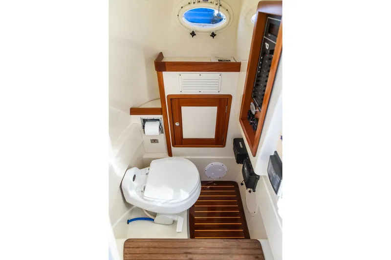 Wayfarer Yacht Photos Pics Hinckley Talaria 29C 2002 boat interior with toilet and wooden accents.