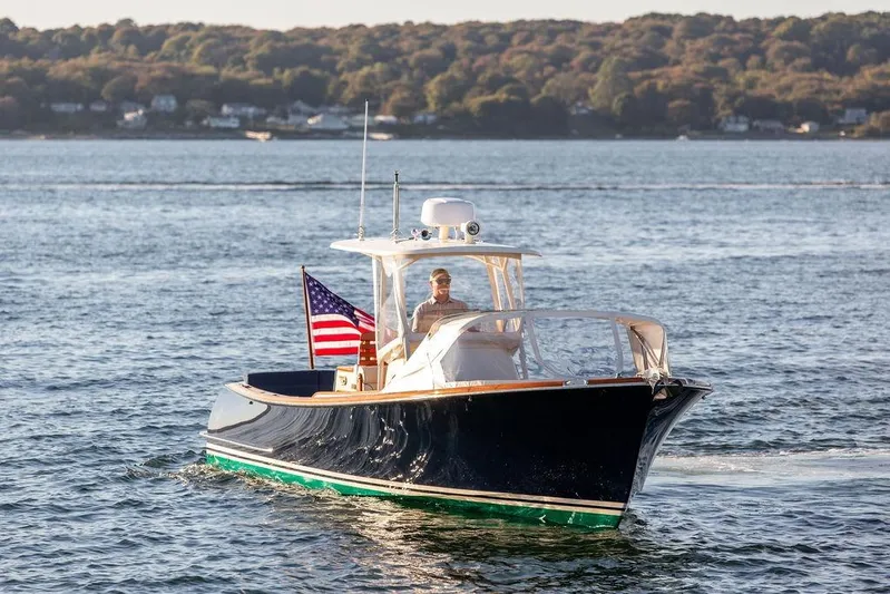 Wayfarer Yacht Photos Pics 2002 Hinckley Talaria 29C cruising on a scenic lake with American flag.