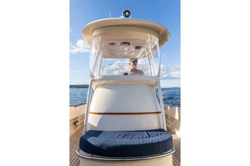 Wayfarer Yacht Photos Pics 2002 Hinckley Talaria 29C boat on water, with person at helm under clear sky.